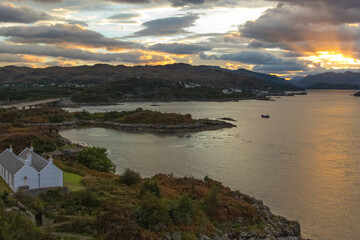 The rocky beach at Elgol on the Isle of Skye in Scotland. minimalist Scottish landscape of a misty morning on a calm, Loch Fada lake on the Isle of Skye, Scotland