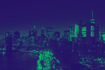 Fototapeta na wymiar Lights of the downtown Manhattan skyline at night in New York City with green and blue duotone colors