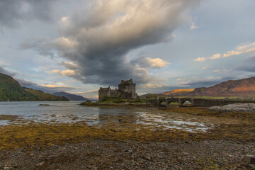 Medieval Eilean Donan Castle in Scotland. minimalist Scottish landscape of a misty morning on a calm, Loch Fada lake on the Isle of Skye, Scotland