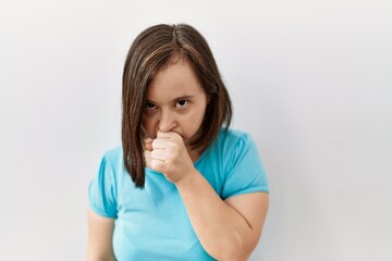 Young down syndrome woman standing over isolated background feeling unwell and coughing as symptom...