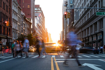 Busy street intersection is crowded with people and cars on 5th Avenue in New York City with...
