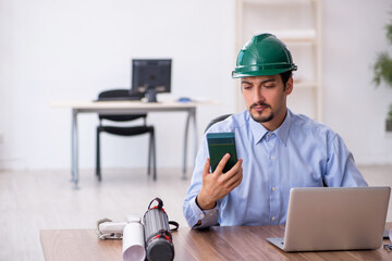 Young male architect working in the office