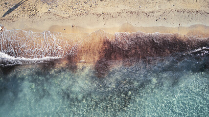 Beautiful birdsview with a drone on the beach, sand, sea and waves.