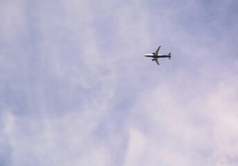 Passenger plane in the cloudy sky