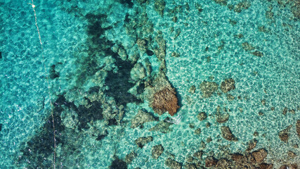 Beautiful birdsview with a drone on the beach, rocks, sand, sea and waves.