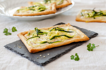 Pizza with zucchini and vegetable cheese. Vegan appetizer
