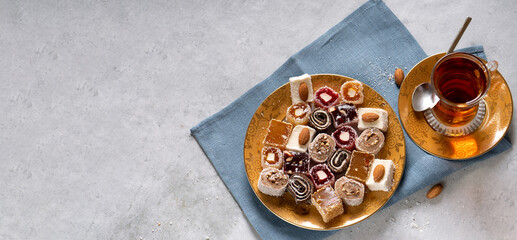 Turkish Delight. view of the tol with a cup of tea and Turkish delight sweets on a plate. A traditional oriental treat is sweetness.