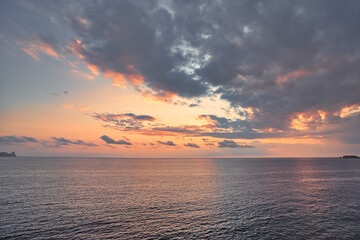Beautiful sunset with a dramatic sky and clouds over the sea