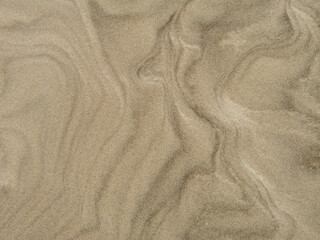 Fototapeta na wymiar Wet sand with shell at beach coastline texture background.summer concept 