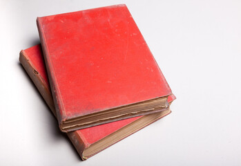 A very old red book cover is placed on a white background.