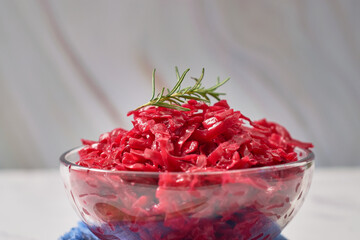 Home-fermented red cabbage sauerkraut in a glass bowl.