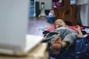 Asian boy addictive watching cartoon