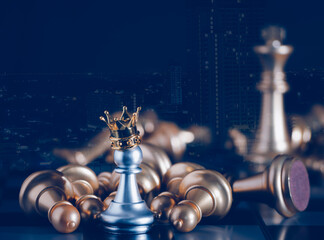 A silver pawn standing crowned in battle chess game on board with gold chess background. To...