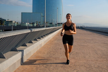 Cheerful jogger running in morning