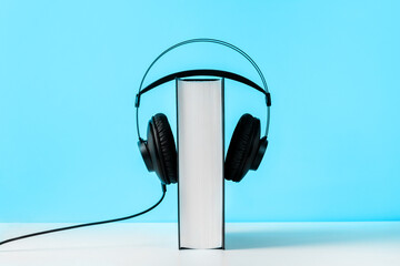 Headphones on book. Audiobook horizontal banner with copyspace. Online education and e-learning concept