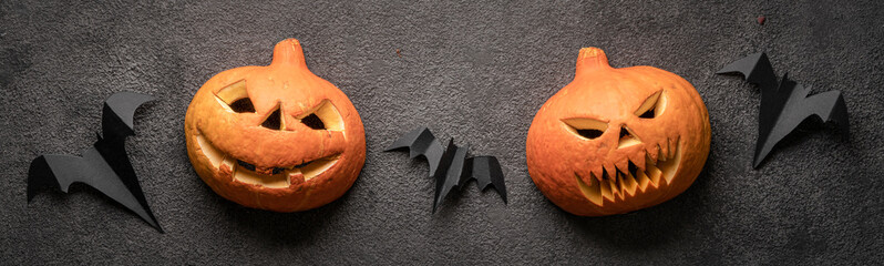 halloween pumpkins, jack's heads on a dark background, panorama. autumn festival of horror and fear