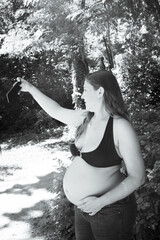 Seven month pregnant woman taking a selfie