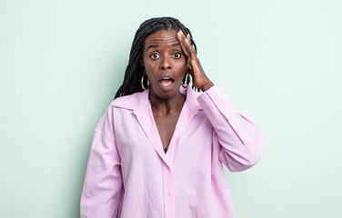 black pretty woman looking happy, astonished and surprised, smiling and realizing amazing and...