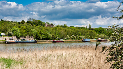 River Medway near Rochester in Kent, England. St Michael & All Angels Church in Cuxton can be seen...
