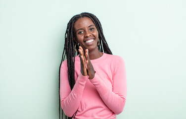 black pretty woman feeling happy and successful, smiling and clapping hands, saying congratulations...