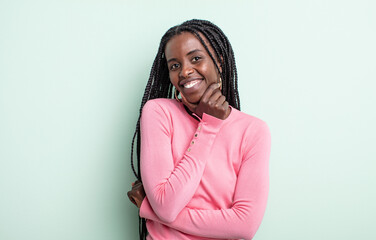 black pretty woman smiling, enjoying life, feeling happy, friendly, satisfied and carefree with...