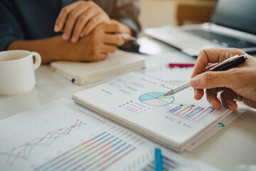 Two businessman investment consultant analyzing company financial report balance working with...
