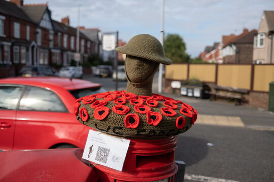 red poppy appeal royal British Legion knitted letter box cover head and helmet armistice day remembrance 