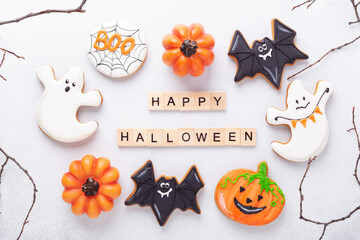 Set of various gingerbread cookies and Happy Halloween wooden blocks on white background. Bright...