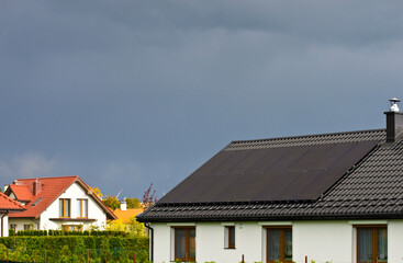 Solar panels on roof of private house on cloudy day
