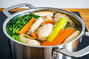 Broth - boiling chicken soup in pot
