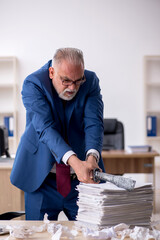 Old male employee unhappy with excessive work in the office
