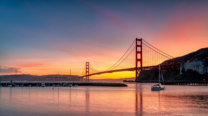 Naklejka na ściany i meble Golden Gate Bridge at sunset from a marina