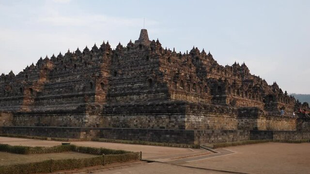 Sunset at Borobudur temple in Java island, Indonesia. The beauty of Majestic Buddhist Temple Borobudur. Mahayana Buddhist temple architecture in Magelang. UNESCO Complex close to Yogyakarta. 4K video.