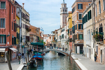 Fototapeta na wymiar A bridge crossing a canal in Venice, Italy