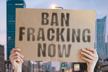 The question " Can the Internet be free? " on a banner in men's hand with blurred background. Employment. No fracking. Dangerous. Damage. Ecological. Fuel. Exploration. Fossil. Negative. Power