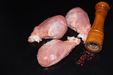 Pieces of turkey drumsticks without skin. Organic turkey meat with greens