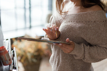 beautiful girl painting artwork in a process