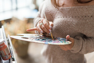 beautiful girl painting artwork in a process