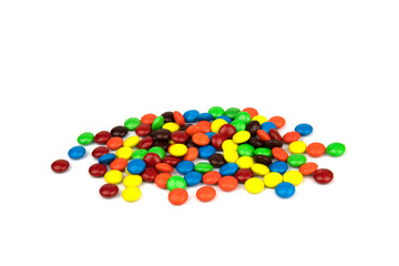 Colorful chocolate in and out of focus on white background.