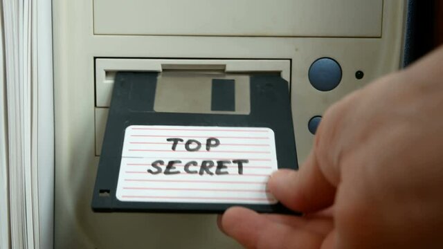 Top secret information on retro vintage floppy disk magnetic computer, concept, closeup