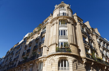 Fototapeta premium The facade of traditional French house with typical balconies and windows. Paris.