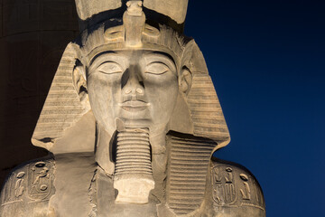 Fototapeta na wymiar The statue of Ramesses II Illuminated at night in the temple of Luxor