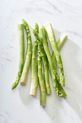 Top view fresh green asparagus on white