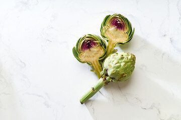 Flat lay with fresh raw artichokes halved for cooking