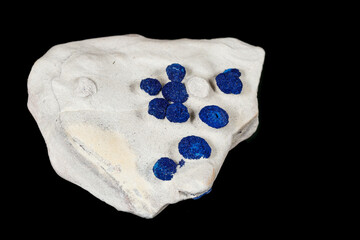 Macro mineral stone Azurite in siltstone against black background