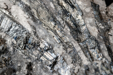 Macro mineral stone Stibnite quartz on a black background