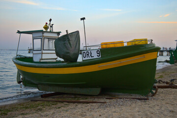 Naklejka na ściany i meble Fishing boat on a beach sand. OR 9 in Gdynia