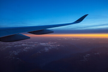 Beautiful panoramic view from inside the airplane during sunset, wing close-up. Switzerland, Zurich...