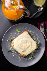 Toasted baguette slice with ham and eggs Benedict under Dutch sauce. traditional Dutch breakfast