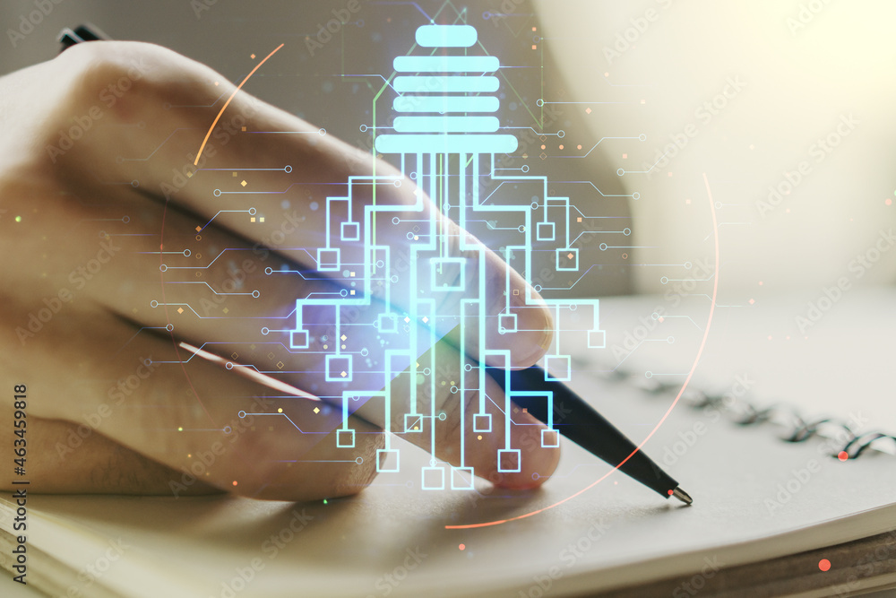 Poster creative light bulb with chip hologram and man hand writing in notepad on background, artificial int